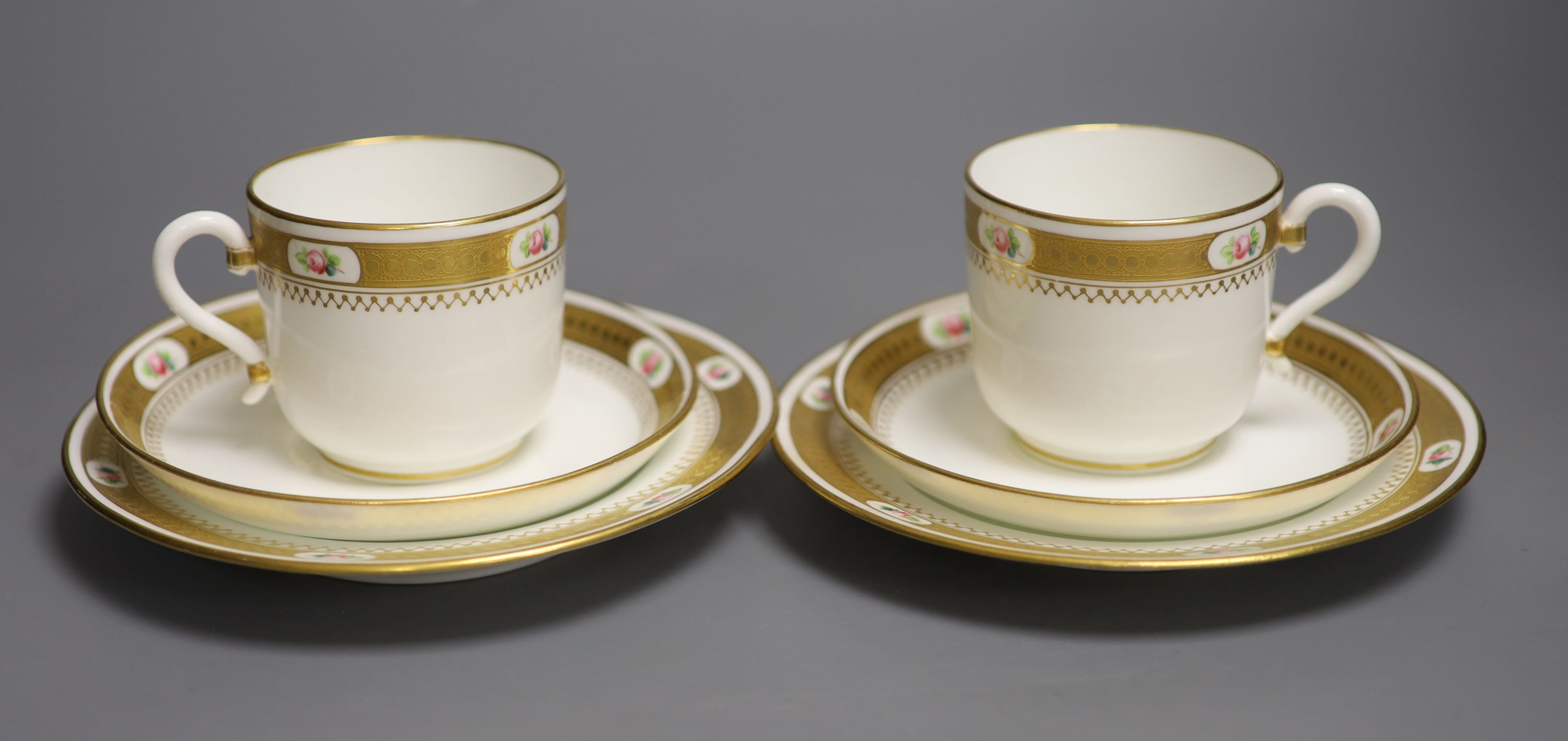 A pair of Minton coffee cups and saucers & pair Minton trios